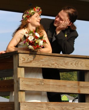 Bride and groom, with flowers.